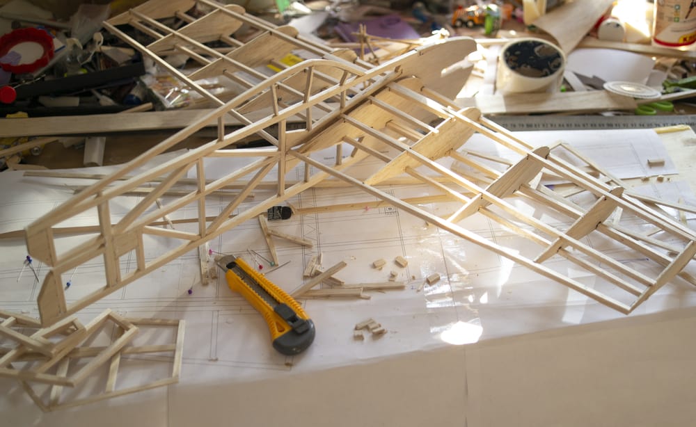 Making model airplane from balsa wood. handcrafted on work table
