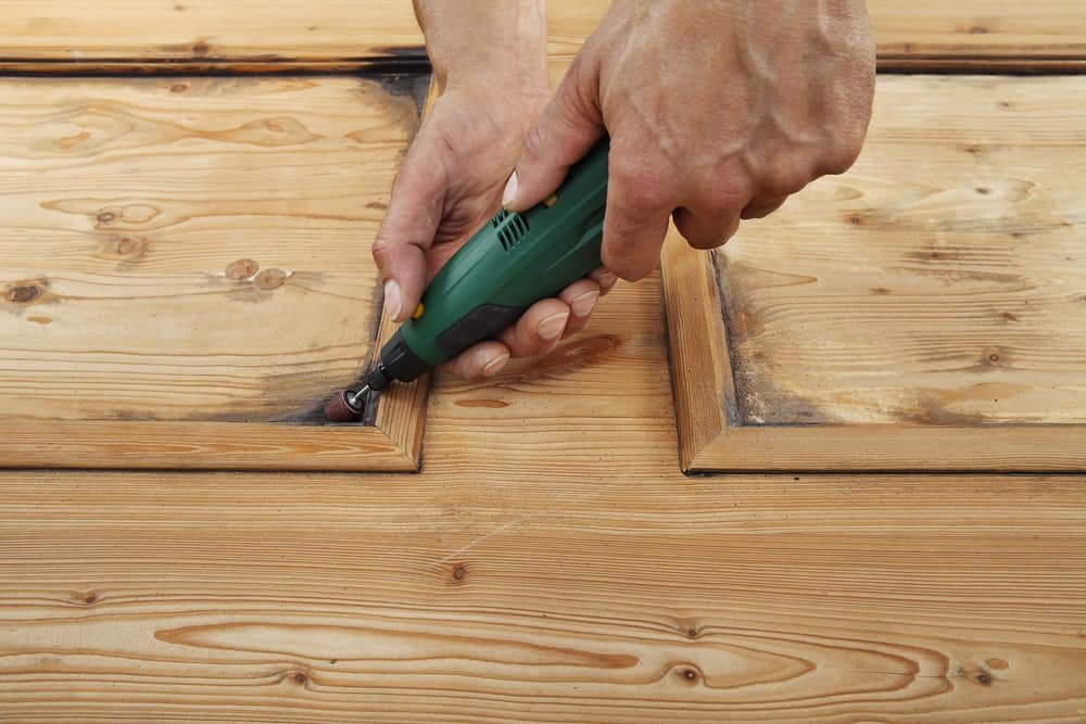 carpenter carving wood with a dremel