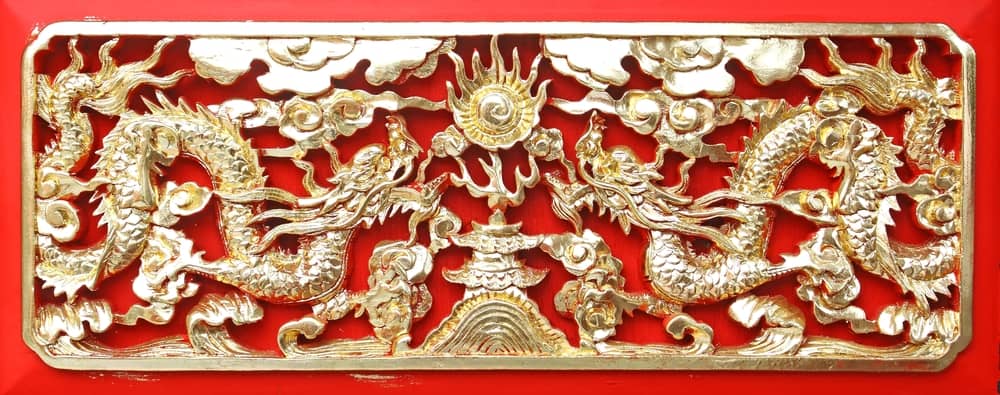 Golden dragon(Chinese: Long) wood carving in Red background